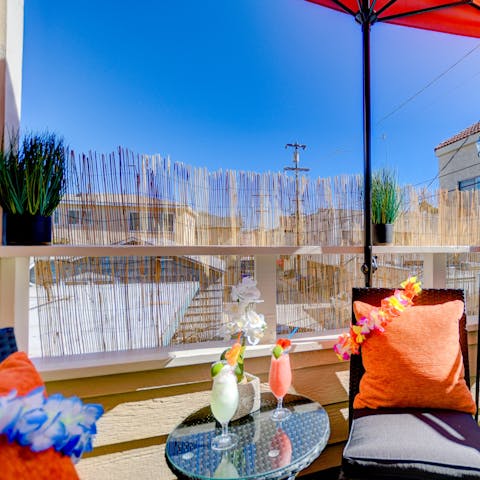 Sip tropical cocktails on the Tiki-themed terrace