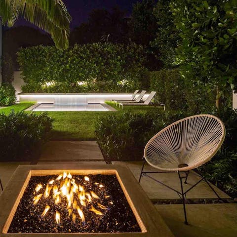 Gather round the firepit and look out over the lush gardens