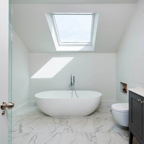 Treat yourself to an indulgent bubble bath in the standalone tub