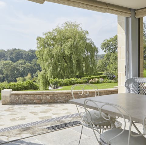 Slide open the full-height doors of the contemporary kitchen conservatory and bring the outdoors in