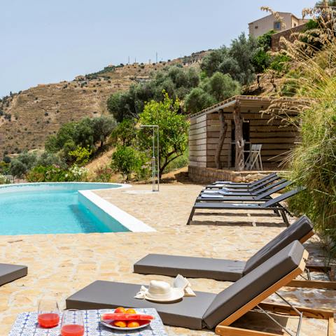 Lie back on the poolside loungers, drink in one hand and a good book in the other as the kids play in the pool