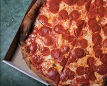 Grab a slice of New York's famous pizza at Joe's Pizza