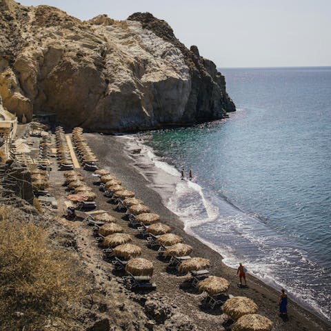 Relax on Kamari Beach, a fifteen-minute drive away