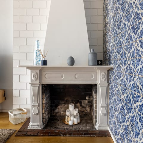 Admire the home's traditional pieces,  including the old fireplace and azulejo tiles