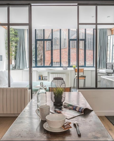 Enjoy a meal at the stylish bench table while relishing the light pouring in through the large windows