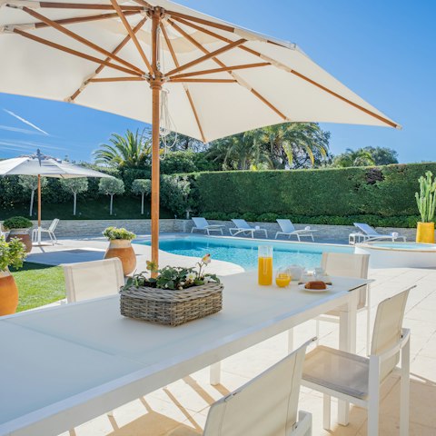 Tuck into an alfresco meal at the poolside