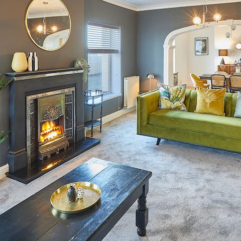 Get cosy by the fireplace in the glamorous lounge area