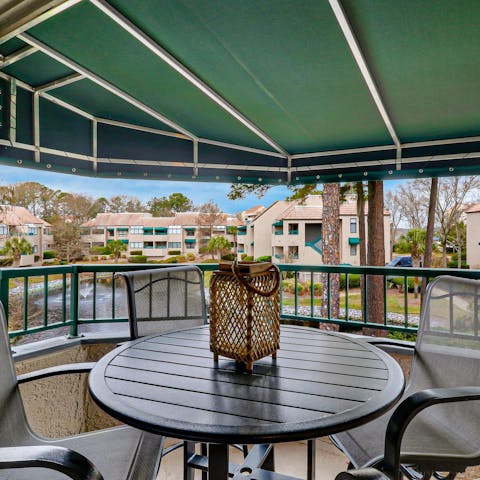 Relax on the private balcony overlooking the lagoon
