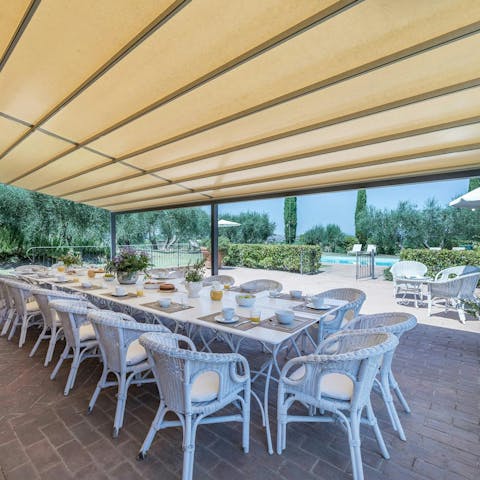 Feast on a chef-prepared meal in the pergola's shade