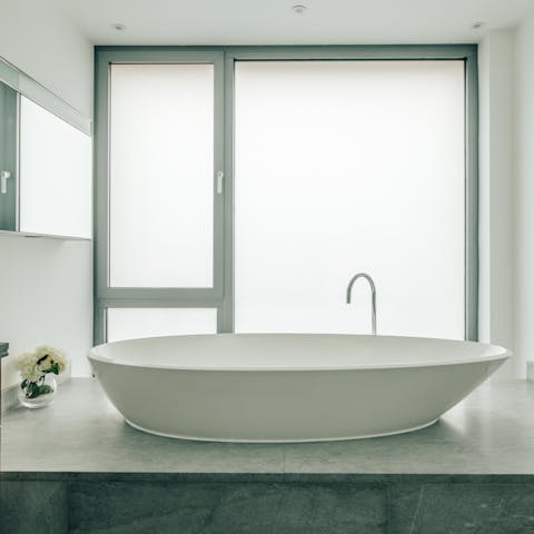 Enjoy a relaxing soak in the luxurious raised bathtub
