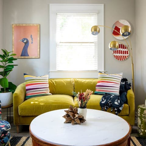 Relax on the bright yellow sofa with a cup of organic coffee