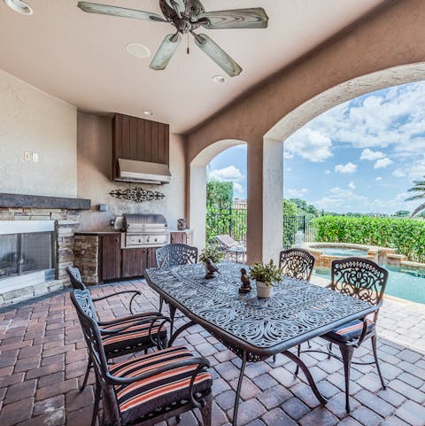 Cook and dine alfresco with the home's summer kitchen