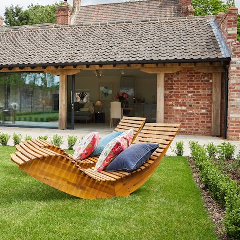 Sip a G&T on the rocking sun loungers after lunch