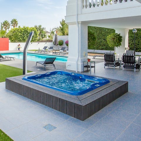 Sink into your bubbling hot tub for the perfect way to round off the day, sipping on a glass of local Cava