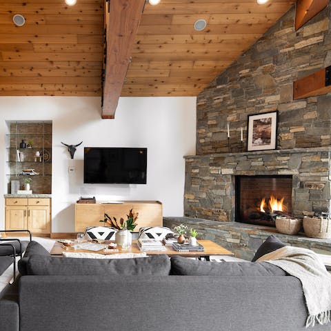 Kindle the statement fireplace and get cosy in the lounge