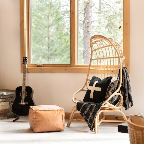Claim the egg chair for reading by the large window