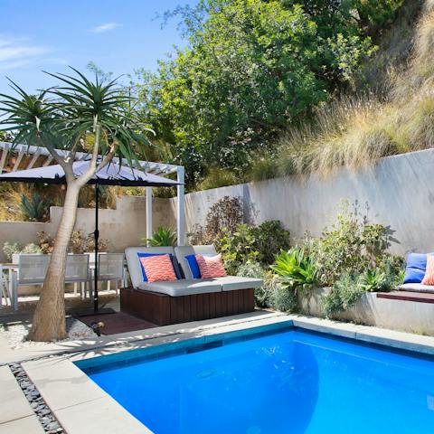 Sunbathe on the day beds around the pool