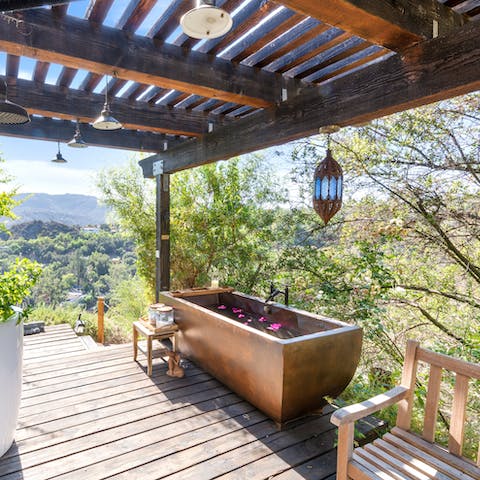 Immerse yourself in the beauty of the natural elements in the copper tub