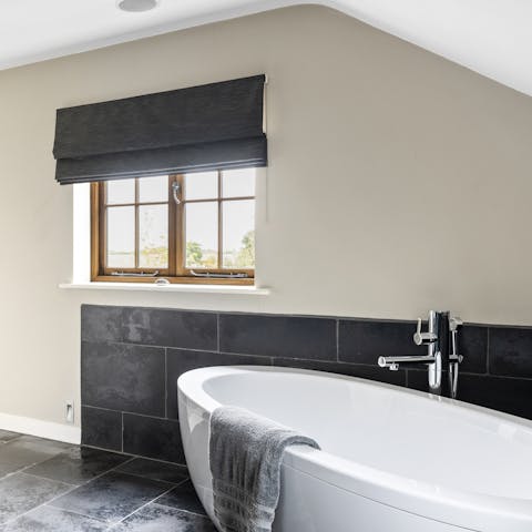 Treat yourself to a rejuvenating soak in the chic freestanding bathtub