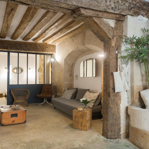 Snuggle up in the homely living space with rustic exposed beams and a brickwork archway