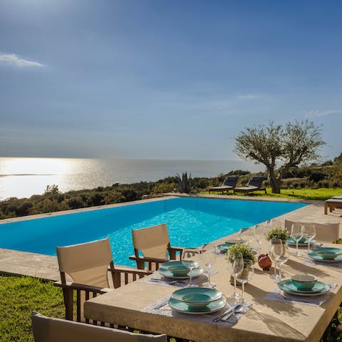 Gather around the table for a poolside dinner