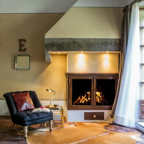 Rest by the fireside in the relaxing lounge area