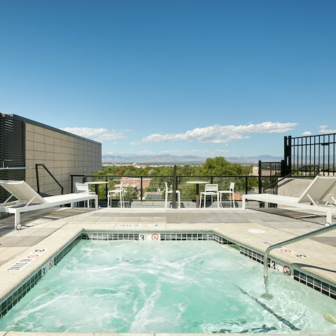 Unwind in the rooftop Jacuzzi with a view out to the mountains