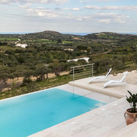 Spend lazy days relaxing by the pool, soaking up the incredible countryside view, before taking a dip to cool off