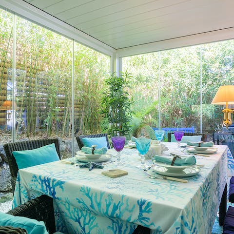 Enjoy dinner in the glass dining room and gaze out at the towering bamboo