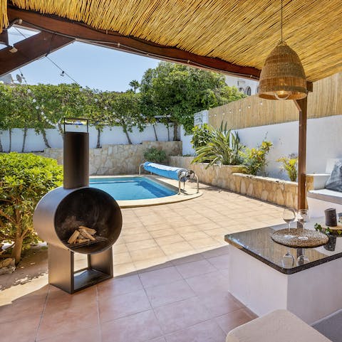 Keep warm after dark, on the outdoor sofas next to the chiminea fire pit