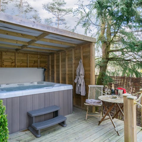 Sip on a glass of wine as you relax in the hot tub
