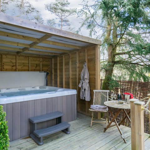 Sip on a glass of wine as you relax in the hot tub