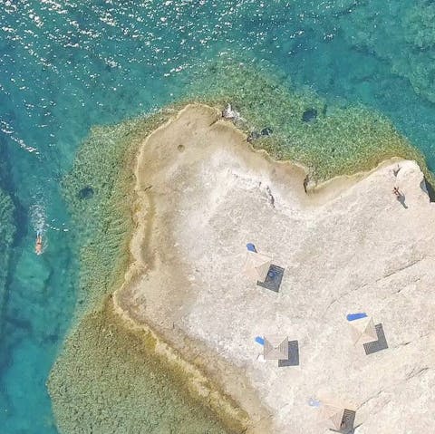 Walk down to the rocky outcrop to swim in the Ionian Ocean