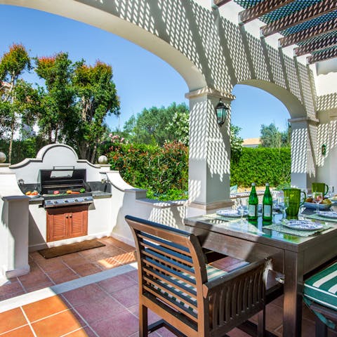 Dine on the sun-dappled terrace, right by the grill