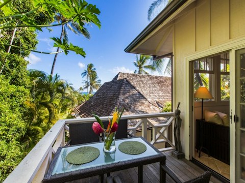 Take breakfast on the terrace with a glimpse of sparkling ocean beyond the trees