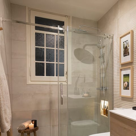Freshen up under the rainfall shower in the elegant bathroom