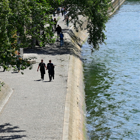 Grab a coffee and stroll along the Seine, a ten-minute walk away