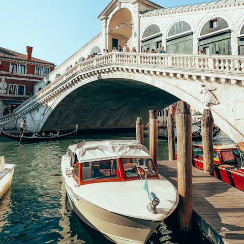 Visit the iconic Rialto Bridge in Venice, just steps from your apartment