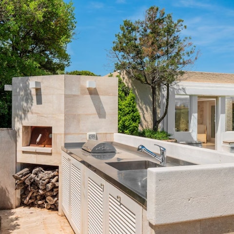 Use the wood-fired pizza oven to prepare a tasty Italian treat