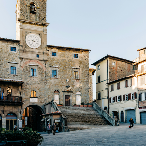 Wander the streets and squares in Cortona, fifteen-minute drive away