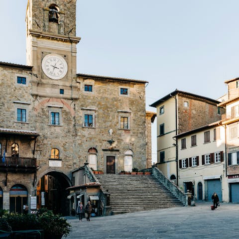 Wander the streets and squares in Cortona, fifteen-minute drive away