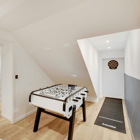 Challenge each other to a game of darts or table football