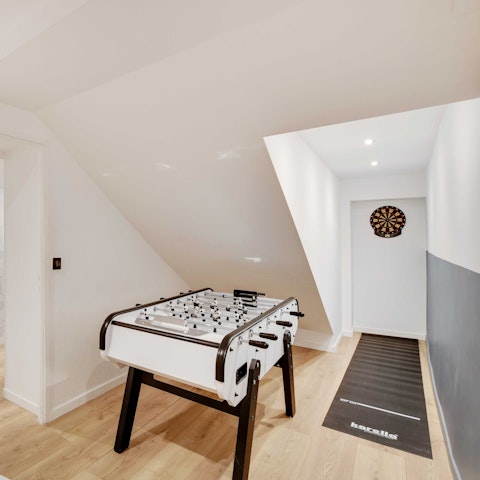Challenge each other to a game of darts or table football