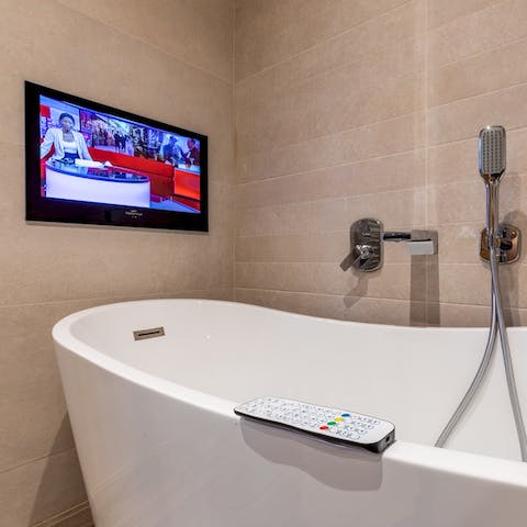 Catch up on the news with a luxurious soak in the freestanding bath