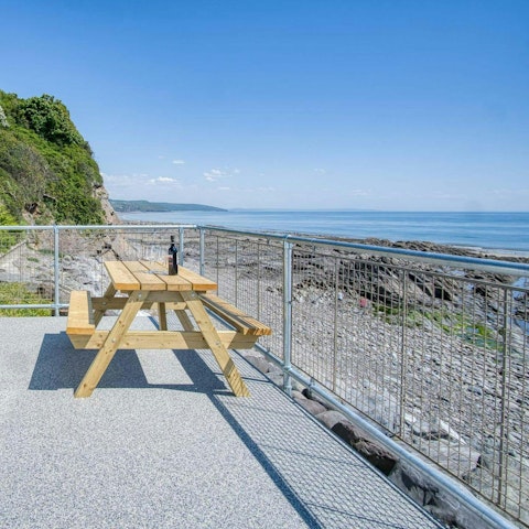 Sip a glass of wine while admiring stretching sea views