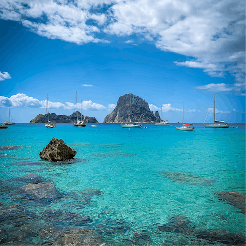 Explore Ibiza's crystal-clear shore from San Antonio, a short drive away
