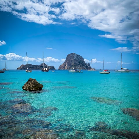 Explore Ibiza's crystal-clear shore from San Antonio, a short drive away