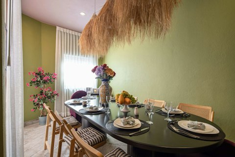 Gather around the dining table for a sociable meal in vibrant surroundings