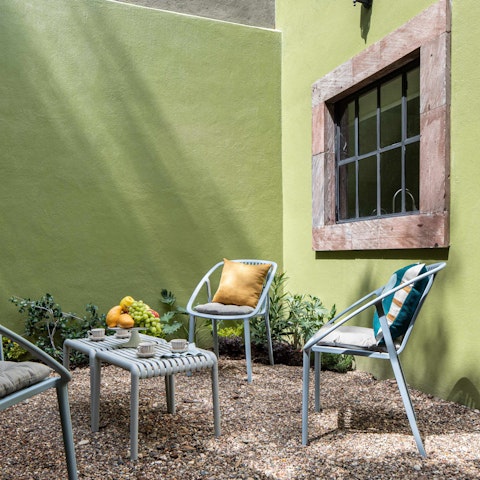 Linger in the sun-soaked courtyard with fresh fruit and coffee