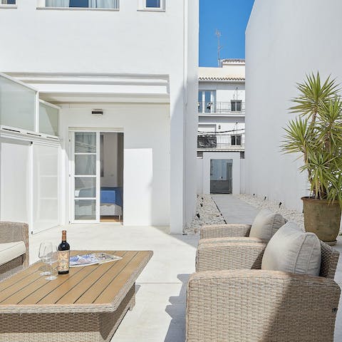 Share a bottle of your favourite wine on the patio at dusk